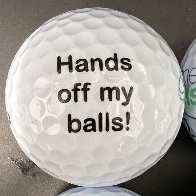 joke golf ball reading 'Hands off my balls!'