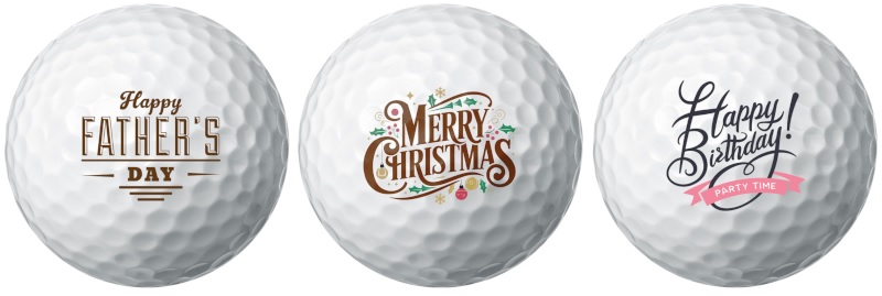 White golf balls with gift messages ('Happy Father's Day', 'Merry Christmas' and 'Happy Birthday') printed on them
