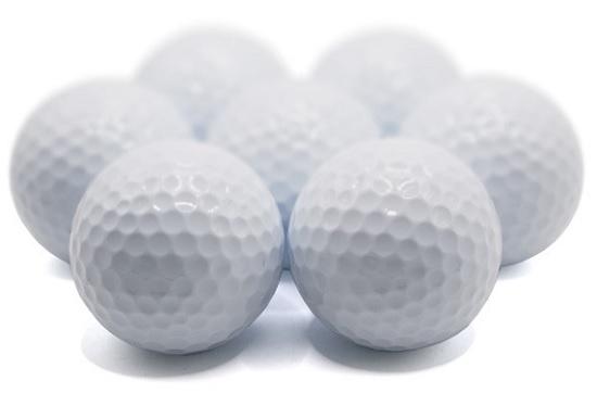 Half a dozen blank white golf balls